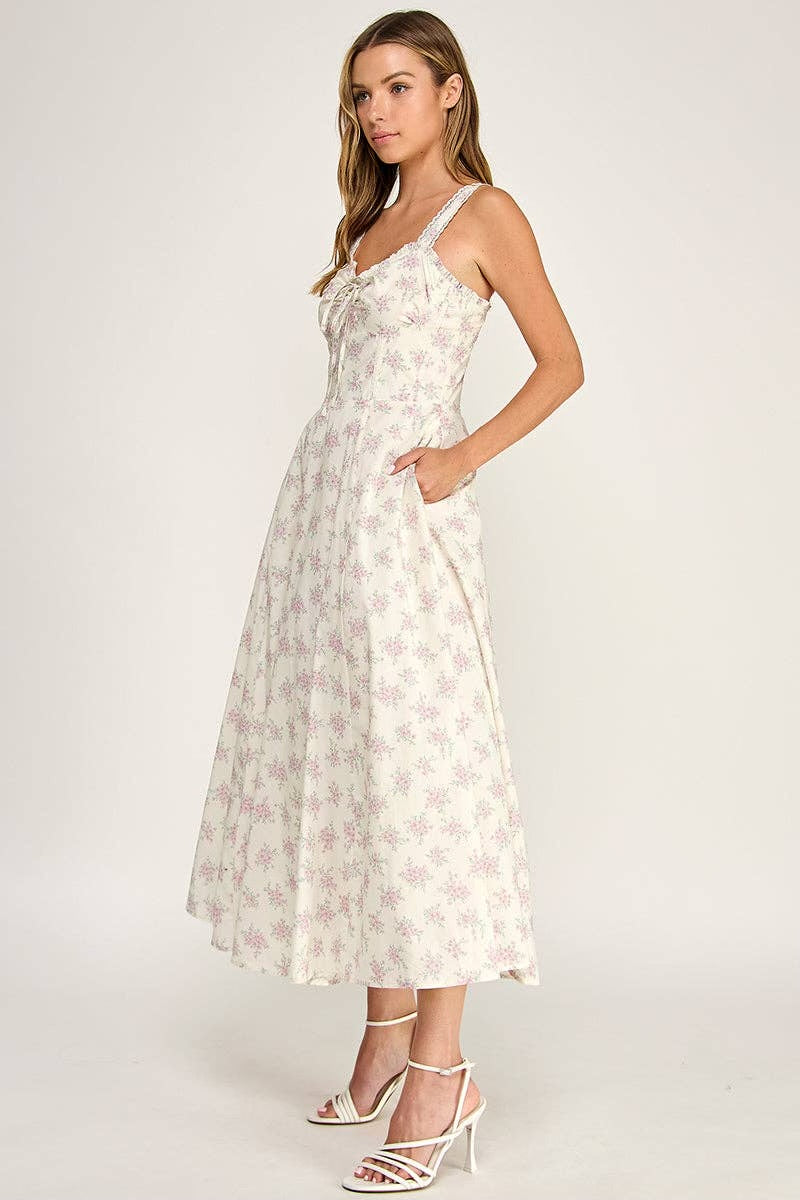 Woman wearing a white floral dress on a plain background
