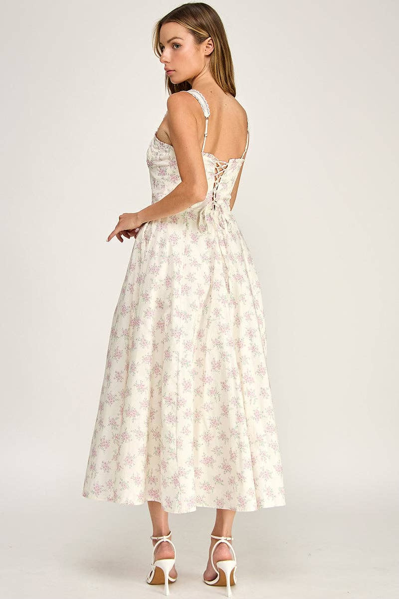 Woman wearing a white floral dress on a plain background