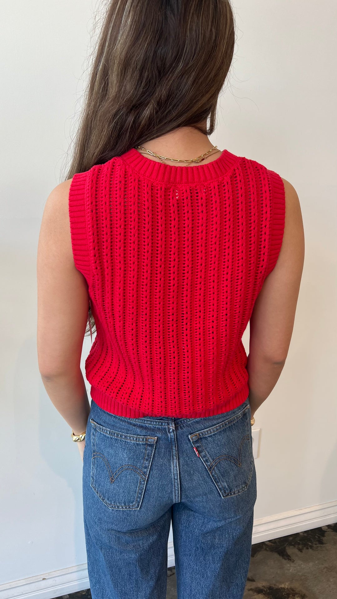 Back view of red sleeveless button-up knit tank top